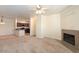 Spacious living room featuring a fireplace and open view of the modern kitchen at 16013 S Desert Foothills Pkwy # 2077, Phoenix, AZ 85048