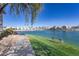 Scenic waterfront view with lush landscaping and a bench for enjoying the serene surroundings at 16013 S Desert Foothills Pkwy # 2077, Phoenix, AZ 85048