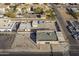 High-angle of a commercial building with parking area, residential homes nearby, and adjacent city street at 1610 W Buckeye Rd, Phoenix, AZ 85007