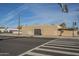 A side view of the tan stucco exterior shows a secure steel door of the commercial building at 1610 W Buckeye Rd, Phoenix, AZ 85007