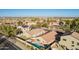 Scenic aerial view showcasing home's backyard oasis, complete with pool, lawn and landscaping at 16412 N 168Th Ln, Surprise, AZ 85388