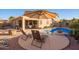 Beautiful backyard featuring a pool, lounge chairs, and a covered patio for ultimate relaxation and entertainment at 16412 N 168Th Ln, Surprise, AZ 85388