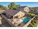 Backyard aerial view showcasing a beautiful pool, patio, desert landscaping and privacy fence at 16412 N 168Th Ln, Surprise, AZ 85388