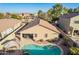 Inviting backyard oasis featuring a sparkling pool, covered patio, and desert landscaping at 16412 N 168Th Ln, Surprise, AZ 85388