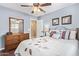 Cozy bedroom with light blue walls, a dresser, and a view of the closet and hallway at 16412 N 168Th Ln, Surprise, AZ 85388