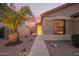 Charming home entrance with a well-lit walkway, desert landscaping, and a welcoming front door at 16412 N 168Th Ln, Surprise, AZ 85388