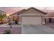 Inviting home exterior showcasing a two-car garage, desert landscaping, and a charming architectural design at 16412 N 168Th Ln, Surprise, AZ 85388