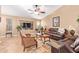 Comfortable living room featuring stylish furnishings, a ceiling fan, and a large television at 16412 N 168Th Ln, Surprise, AZ 85388