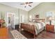 Serene main bedroom featuring a wooden bed frame, plush bedding, and a connecting bathroom and closet at 16412 N 168Th Ln, Surprise, AZ 85388