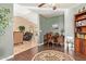 Stylish office with a desk, bookcase, and decorative rug connecting to a comfortable living space at 16412 N 168Th Ln, Surprise, AZ 85388