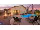 Resort-style pool and patio with a fire pit, comfortable lounge chairs, and an umbrella, perfect for outdoor relaxation at 16412 N 168Th Ln, Surprise, AZ 85388