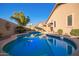 Inviting pool area with mature landscaping, offering a serene and private retreat for relaxation and recreation at 16412 N 168Th Ln, Surprise, AZ 85388