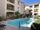 View of the outdoor community pool in the home with buildings and balconies surrounding at 16631 E El Lago Blvd # 214, Fountain Hills, AZ 85268