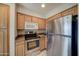 Kitchen featuring stainless steel appliances, wooden cabinets, and ample counter space at 16631 E El Lago Blvd # 214, Fountain Hills, AZ 85268