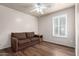 Cozy bedroom with sleek flooring, neutral walls, large shuttered windows, and a comfortable couch at 16643 N 19Th St, Phoenix, AZ 85022