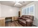 This bedroom features sleek hardwood floors, a large window, a ceiling fan, and an expansive work space at 16643 N 19Th St, Phoenix, AZ 85022