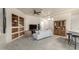 Open concept living room with built-in shelving, tile flooring, and neutral colors, leading into the kitchen at 16643 N 19Th St, Phoenix, AZ 85022