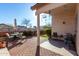 Inviting covered patio with brick flooring, outdoor seating, and decorative windchimes create a relaxing space at 16643 N 19Th St, Phoenix, AZ 85022