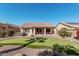 Expansive backyard showcasing a putting green, patio area, and well-maintained desert landscape at 16713 W Monte Vista Rd, Goodyear, AZ 85395