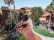 Beautiful entryway to the community clubhouse with lush landscaping and covered entry at 16713 W Monte Vista Rd, Goodyear, AZ 85395