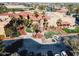 Aerial view of a community clubhouse featuring lush landscaping, parking, and classic architecture at 16713 W Monte Vista Rd, Goodyear, AZ 85395