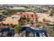 Aerial view of the grand community clubhouse with lush landscaping and ample parking at 16713 W Monte Vista Rd, Goodyear, AZ 85395