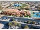 Aerial view of the community clubhouse, tennis courts and a golf course in a well-manicured setting at 16713 W Monte Vista Rd, Goodyear, AZ 85395