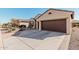 Beautiful home with mature landscaping, a 3-car garage, and a long, wide driveway at 16713 W Monte Vista Rd, Goodyear, AZ 85395