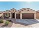 Charming single-story home with a desert-style front yard and a three-car garage at 16713 W Monte Vista Rd, Goodyear, AZ 85395