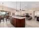 Modern kitchen featuring a large island, stainless appliances, and a view of the living area at 16713 W Monte Vista Rd, Goodyear, AZ 85395