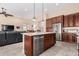 Contemporary kitchen with stainless steel appliances, a breakfast bar, and an open floor plan at 16713 W Monte Vista Rd, Goodyear, AZ 85395