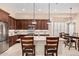 Lovely kitchen with stainless appliances, quartz countertops, and seating at the island at 16713 W Monte Vista Rd, Goodyear, AZ 85395