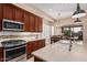 An open kitchen with stainless steel appliances, tile backsplash, and plenty of counter space at 16713 W Monte Vista Rd, Goodyear, AZ 85395