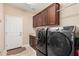 Laundry room with washer, dryer, and upper cabinets at 16713 W Monte Vista Rd, Goodyear, AZ 85395