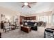 Open-concept living room featuring recessed lighting, ceiling fan, and views of the kitchen and dining areas at 16713 W Monte Vista Rd, Goodyear, AZ 85395