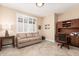 Home office with tile floors, built-in cabinets, and a large window at 16713 W Monte Vista Rd, Goodyear, AZ 85395