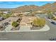 Stunning aerial view of a home with desert landscaping, tile roof, and a convenient three-car garage at 1728 W Eagle Talon Trl, Phoenix, AZ 85085