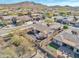 Aerial view of a home with desert landscaping, a putting green, and mountain views at 1728 W Eagle Talon Trl, Phoenix, AZ 85085