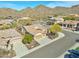 Gorgeous aerial view of a home showing the tile roof, three-car garage, desert landscaping, and mountain views at 1728 W Eagle Talon Trl, Phoenix, AZ 85085