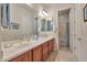 Bathroom featuring double sinks, a large mirror, and access to a separate shower and toilet area at 1728 W Eagle Talon Trl, Phoenix, AZ 85085