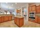 Well-equipped kitchen with stainless steel appliances and wooden cabinets at 1728 W Eagle Talon Trl, Phoenix, AZ 85085