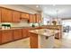 Spacious kitchen featuring wooden cabinetry, granite countertops, and a convenient center island at 1728 W Eagle Talon Trl, Phoenix, AZ 85085