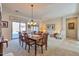 Bright living space featuring a dining table, sofa, and sliding glass doors at 1728 W Eagle Talon Trl, Phoenix, AZ 85085