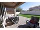 Covered brick patio with outdoor seating area and view of the backyard at 17441 W Rock Ledge Rd, Goodyear, AZ 85338