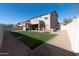 Backyard with artificial grass and gravel, showcasing the exterior of the house at 17441 W Rock Ledge Rd, Goodyear, AZ 85338