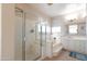 Bright bathroom with glass enclosed walk-in shower, bathtub, and double sink vanity at 17441 W Rock Ledge Rd, Goodyear, AZ 85338