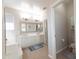 Bright bathroom with double sink vanity, framed mirror, and access to the toilet room at 17441 W Rock Ledge Rd, Goodyear, AZ 85338