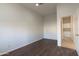 Empty bedroom features wood floors, neutral paint, and an open doorway at 17441 W Rock Ledge Rd, Goodyear, AZ 85338