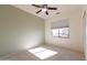 This bedroom features a ceiling fan, window, neutral paint, and carpet at 17441 W Rock Ledge Rd, Goodyear, AZ 85338