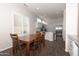 Dining area with a wooden table, adjacent to a kitchen with stainless steel appliances at 17441 W Rock Ledge Rd, Goodyear, AZ 85338